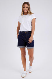 A model wearing the Elements Devi Denim Shorts in colour Darkblue (Blue), from the front, showing the whole outfit