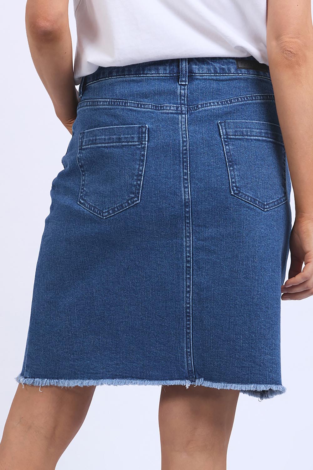 A model wearing the Elements Belle Skirt in colour Midblue (Blue), from the back