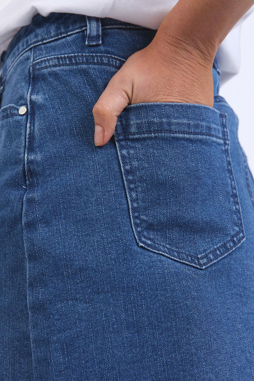A model wearing the Elements Belle Skirt in colour Midblue (Blue), from the front, cropped image