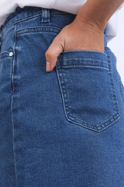 A model wearing the Elements Belle Skirt in colour Midblue (Blue), from the front, cropped image