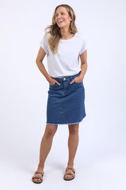 A model wearing the Elements Belle Skirt in colour Midblue (Blue), from the front, showing the whole outfit