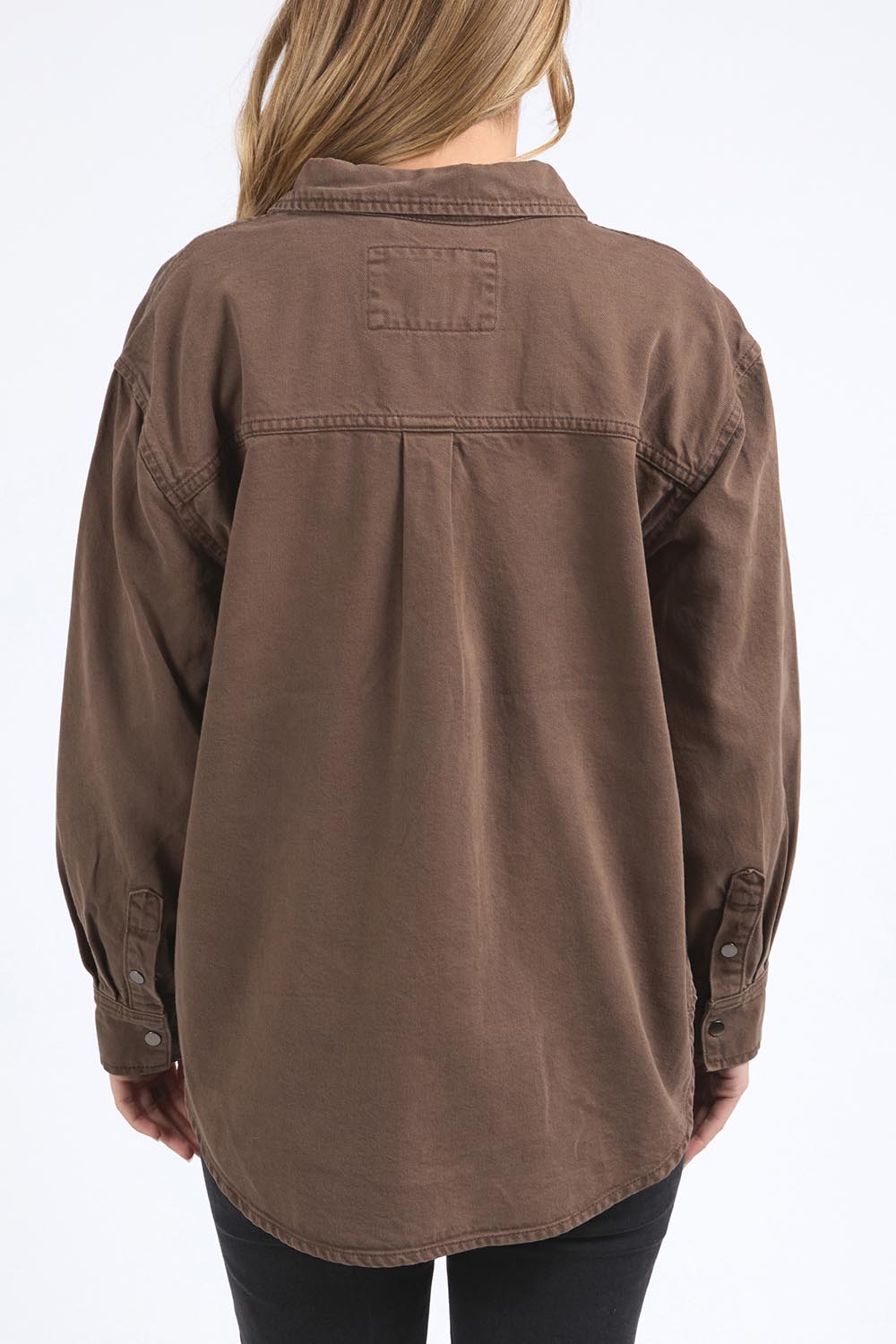 A model wearing the Daisy Denim Overshirt in colour Chocolate, from the back