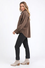 A model wearing the Daisy Denim Overshirt in colour Chocolate, from the front, showing the whole outfit