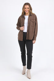 A model wearing the Daisy Denim Overshirt in colour Chocolate, from the front, showing the whole outfit
