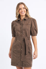 A model wearing the Talbert Dress in colour Chocolate, from the front, cropped image