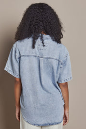 Model Ziara wearing size 10 of the Daisy Denim Ss Shirt in colour Lightblue (Blue), from the back