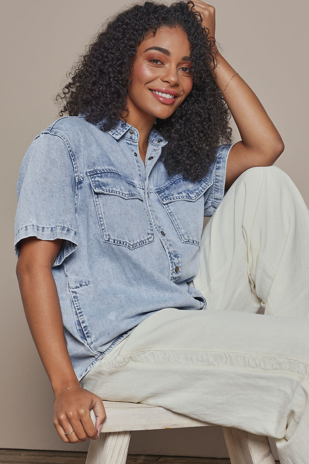 Model Ziara wearing size 10 of the Daisy Denim Ss Shirt in colour Lightblue (Blue), from the front, cropped image