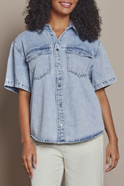 Model Ziara wearing size 10 of the Daisy Denim Ss Shirt in colour Lightblue (Blue), from the front, cropped image