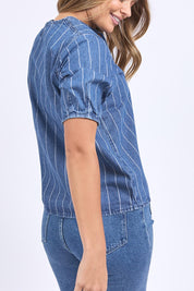 A model wearing the Tivoli Denim Top in colour Midblue (Blue), from the back