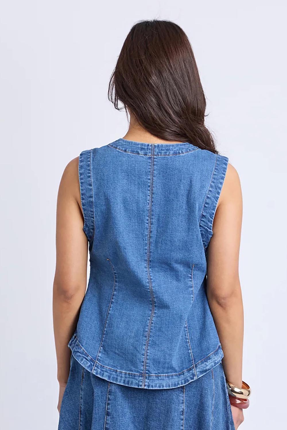 A model wearing the Abbott Denim Vest in colour Midblue (Blue), from the back