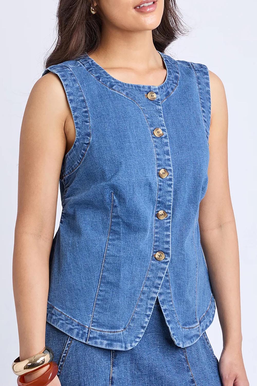 A model wearing the Abbott Denim Vest in colour Midblue (Blue), from the front, cropped image