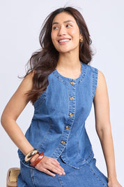 A model wearing the Abbott Denim Vest in colour Midblue (Blue), from the front, cropped image