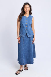 A model wearing the Abbott Denim Vest in colour Midblue (Blue), from the front, showing the whole outfit