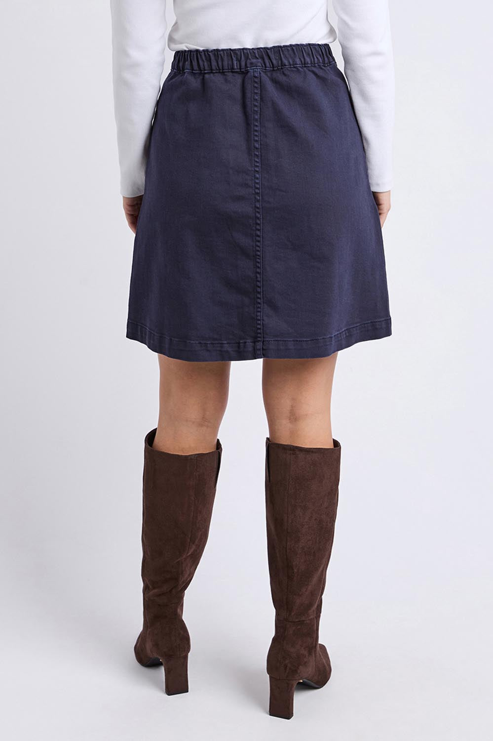 A model wearing the Elements Amanda Denim Skirt in colour Darksapph (Blue), from the back