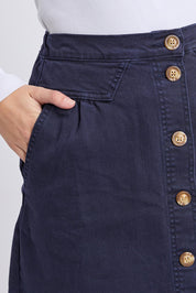 A model wearing the Elements Amanda Denim Skirt in colour Darksapph (Blue), from the front, cropped image