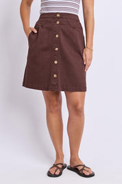 Model Genericm wearing size sample of the Elements Amanda Denim Skirt – Chocolate in colour Chocolate, in a cropped view