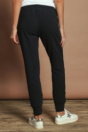 Model Madeline wearing size 10 of the Elements Lazy Days Pant in colour Black (Black), from the back