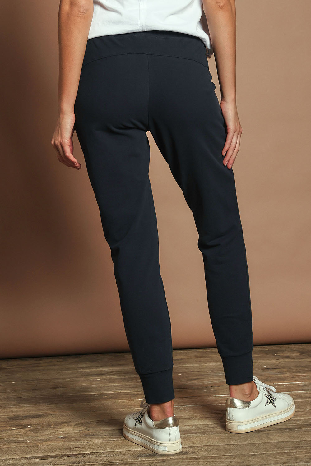 Model Madeline wearing size 10 of the Elements Lazy Days Pant in colour Navy (Blue), from the back