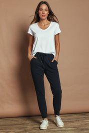 Model Madeline wearing size 10 of the Elements Lazy Days Pant in colour Navy (Blue), from the front, showing the whole outfit