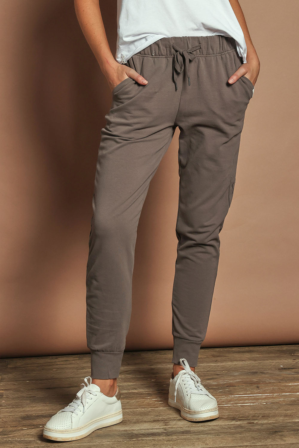 Model Madeline wearing size 10 of the Elements Lazy Days Pant in colour Stonegrey (Grey), from the front, cropped image