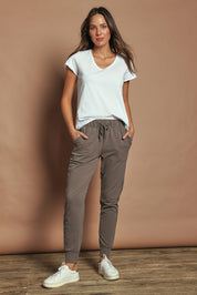 Model Madeline wearing size 10 of the Elements Lazy Days Pant in colour Stonegrey (Grey), from the front, showing the whole outfit