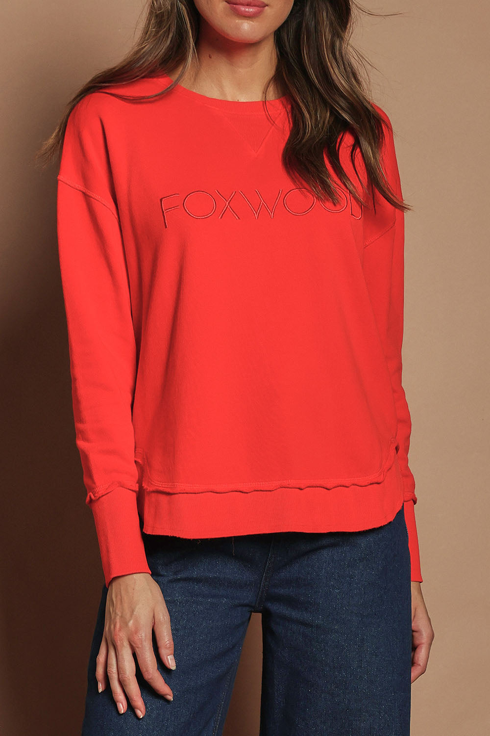 Model Madeline wearing size 10 of the Elements Simplified Cotton Crew in colour Brightred (Red), from the front, cropped image