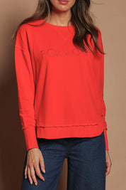 Model Madeline wearing size 10 of the Elements Simplified Cotton Crew in colour Brightred (Red), from the front, cropped image