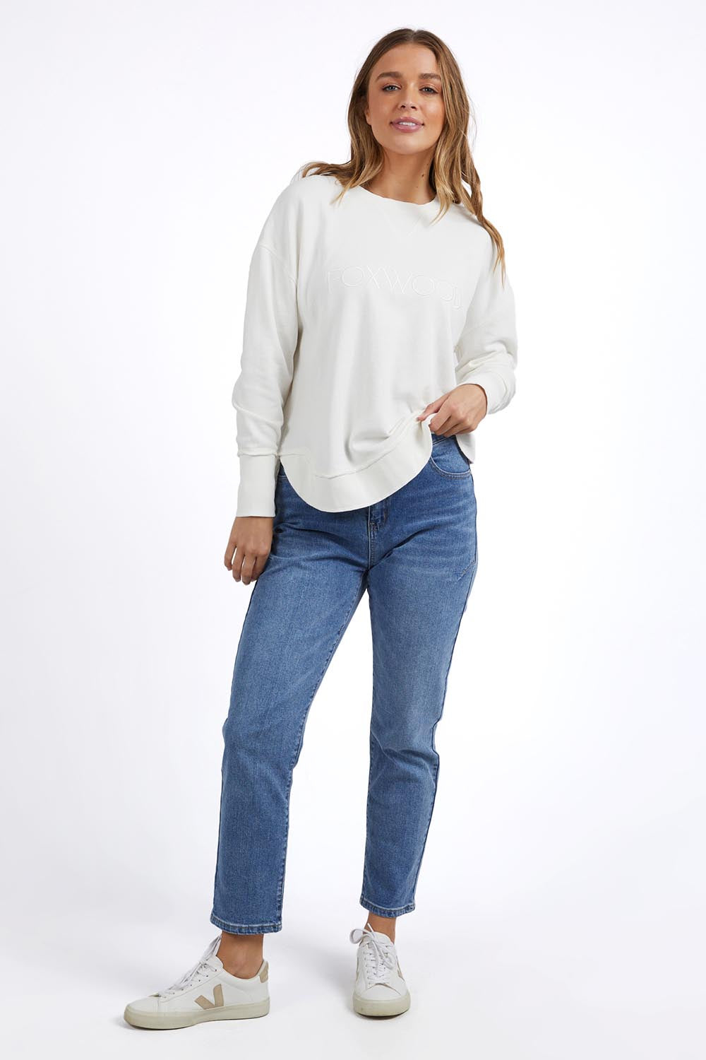 A model wearing the Elements Simplified Cotton Crew in colour Ecru (White), from the front, showing the whole outfit