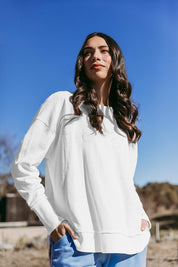 A model wearing the Elements Simplified Cotton Crew in colour Ecru (White), from the front, showing the whole outfit