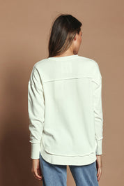 Model Madeline wearing size 10 of the Elements Simplified Cotton Crew in colour Ecru (White), from the back