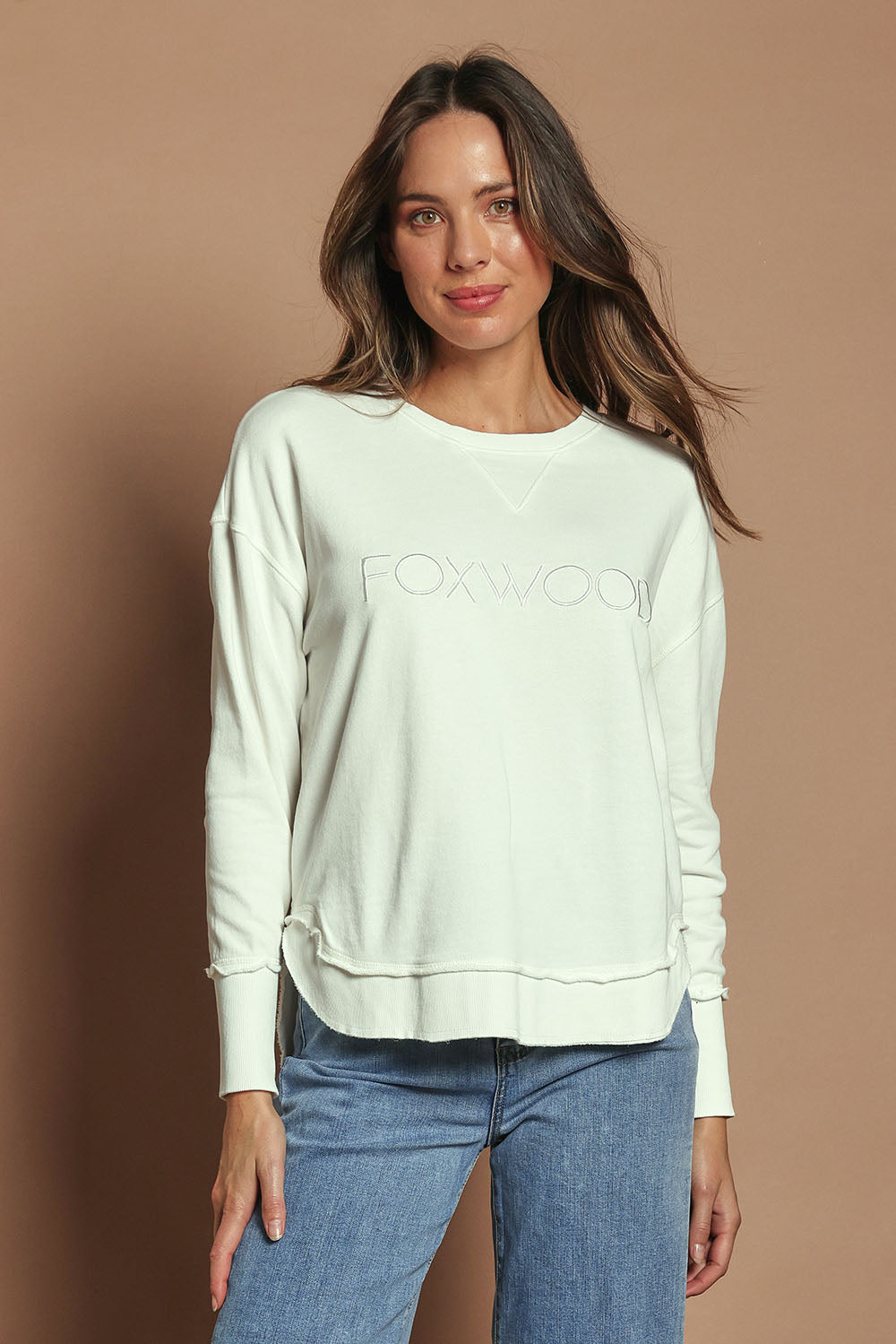 Model Madeline wearing size 10 of the Elements Simplified Cotton Crew in colour Ecru (White), from the front, cropped image