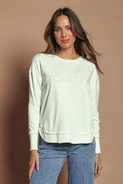 Model Madeline wearing size 10 of the Elements Simplified Cotton Crew in colour Ecru (White), from the front, cropped image