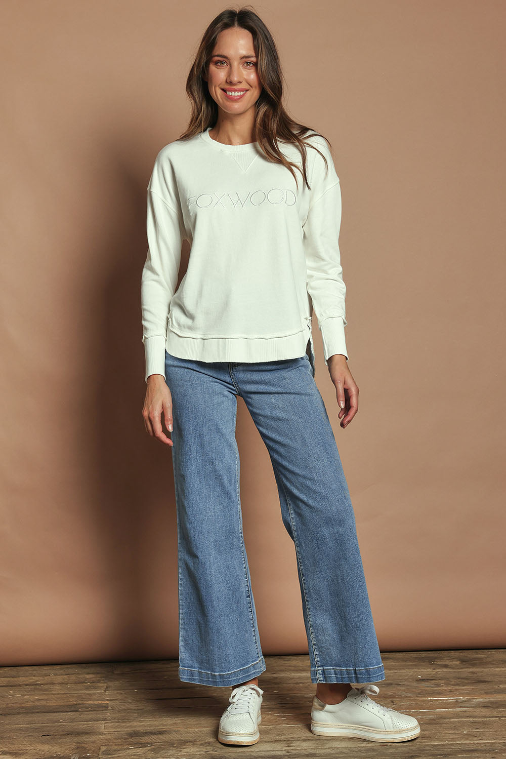 Model Madeline wearing size 10 of the Elements Simplified Cotton Crew in colour Ecru (White), from the front, showing the whole outfit