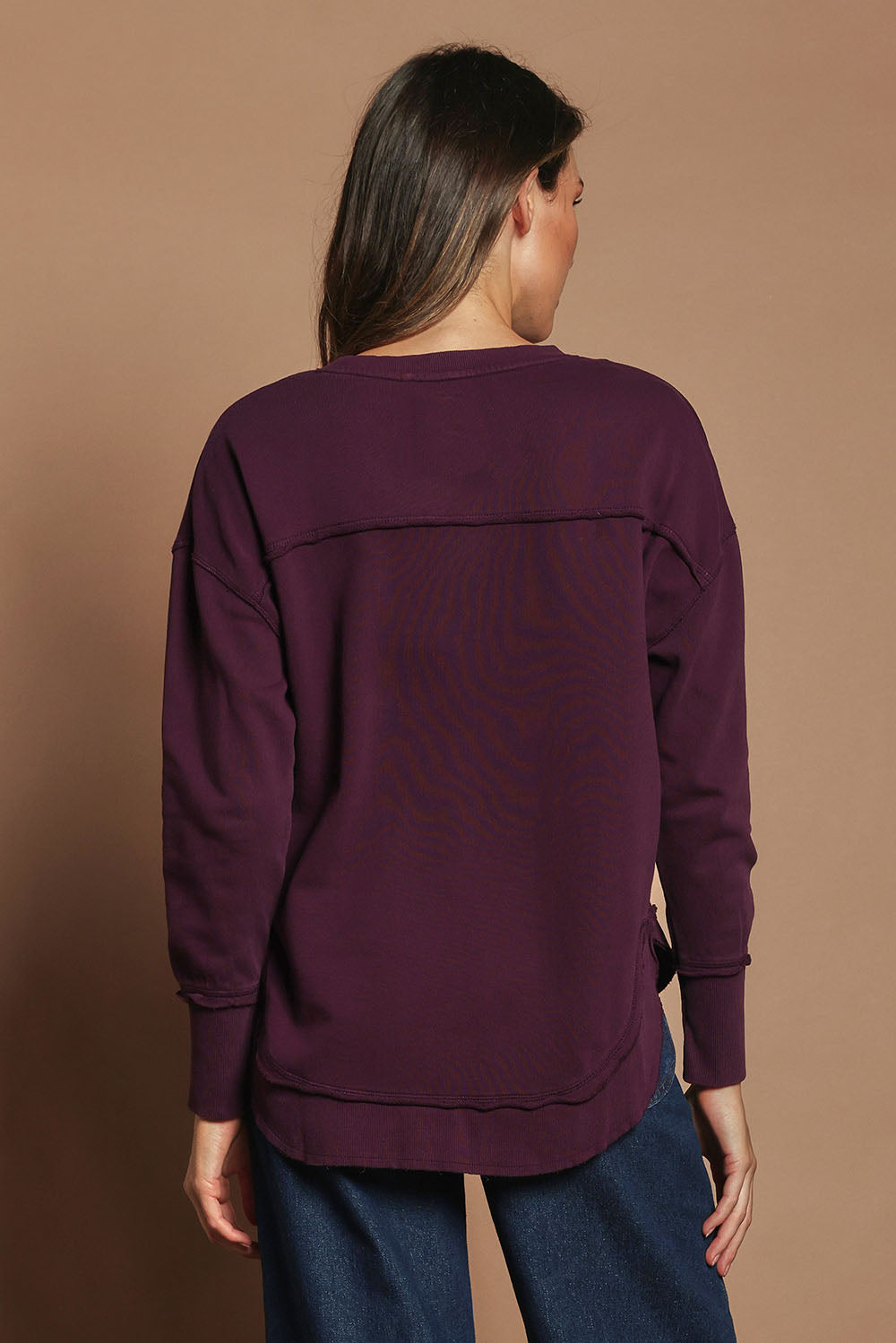 Model Madeline wearing size 10 of the Elements Simplified Cotton Crew in colour Plum (Purple), from the back