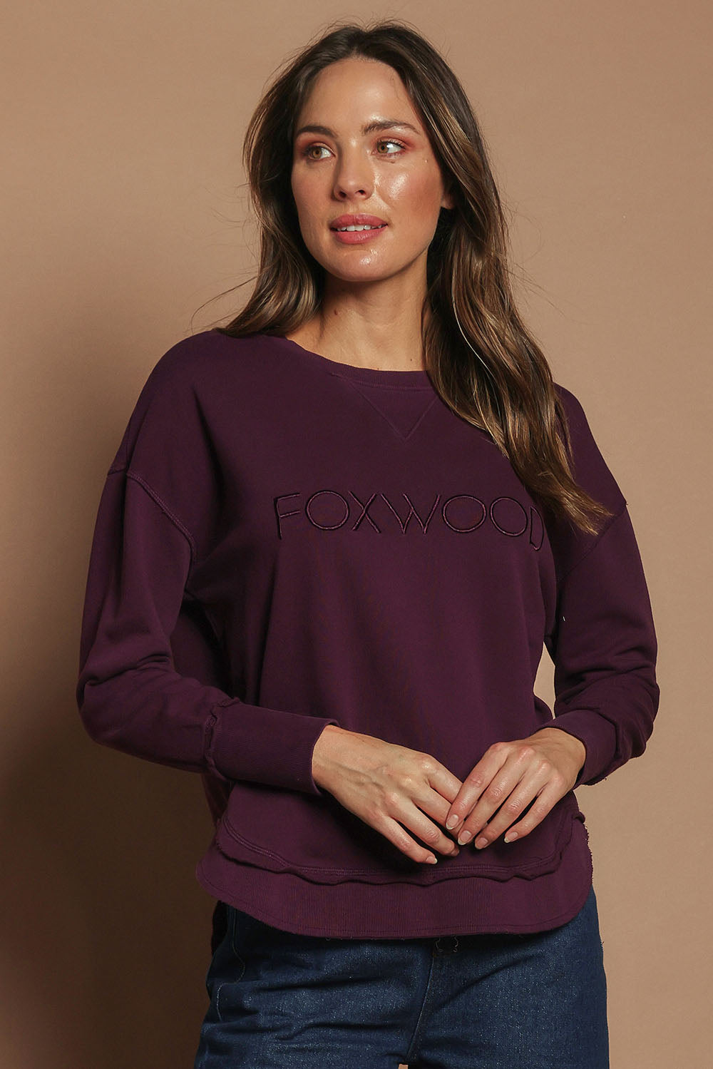 Model Madeline wearing size 10 of the Elements Simplified Cotton Crew in colour Plum (Purple), from the front, cropped image
