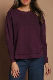 Model Madeline wearing size 10 of the Elements Simplified Cotton Crew in colour Plum (Purple), from the front, cropped image