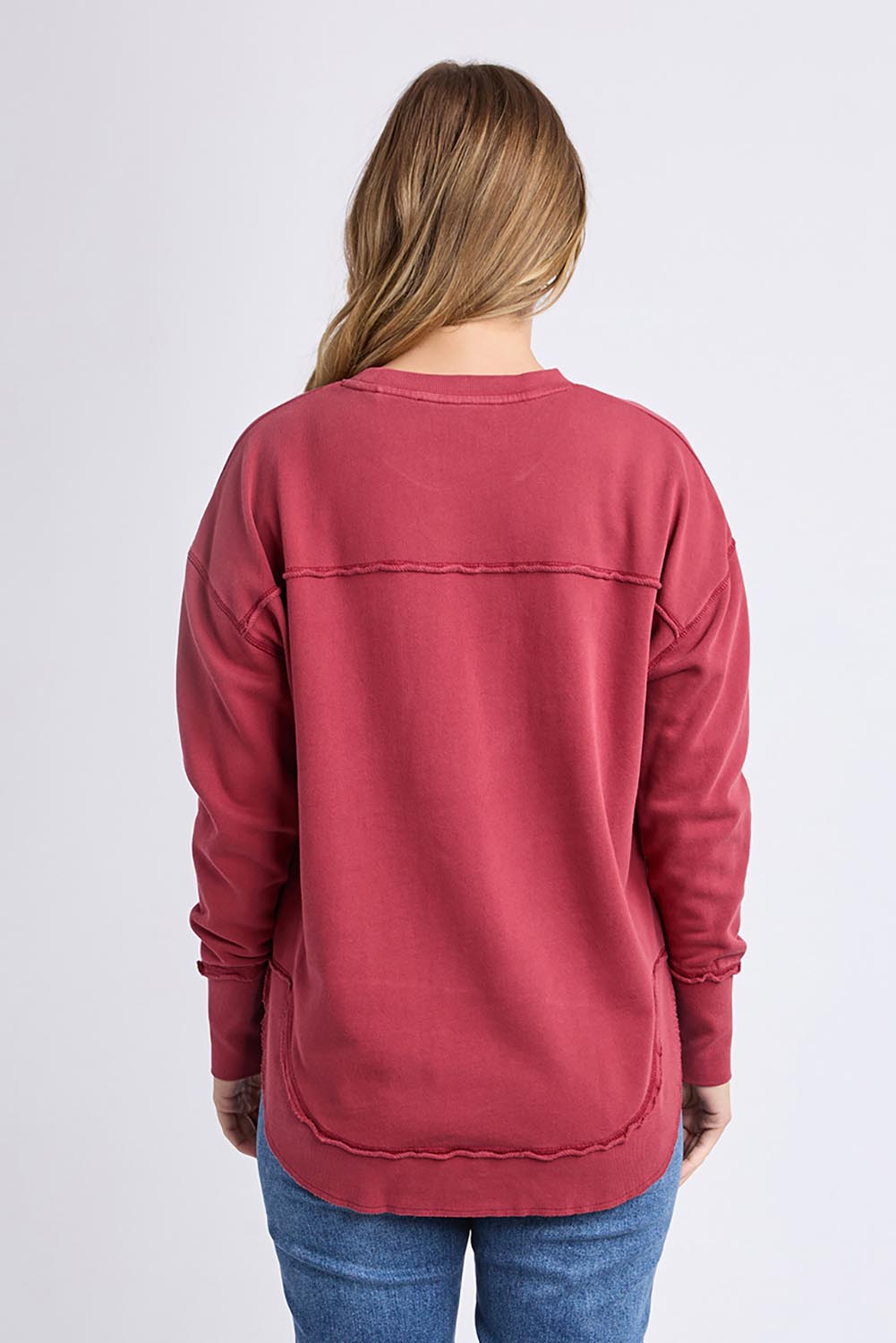 A model wearing the Elements Simplified Cotton Crew in colour Rust (Red), from the back