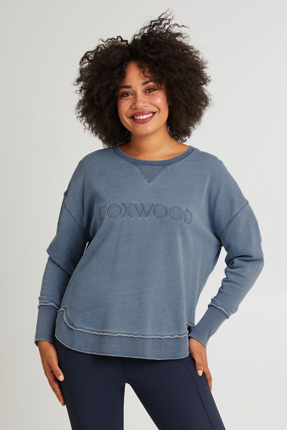 Model Olivia wearing size 10 of the Elements Washed Simplified Crew in colour Blue (Blue), from the front, cropped image