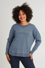 Model Olivia wearing size 10 of the Elements Washed Simplified Crew in colour Blue (Blue), from the front, cropped image