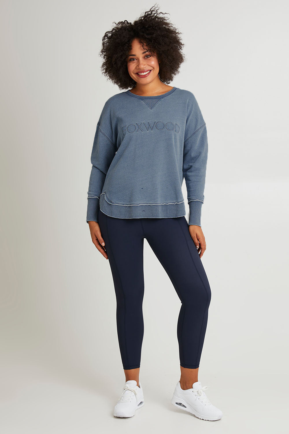 Model Olivia wearing size 10 of the Elements Washed Simplified Crew in colour Blue (Blue), from the front, showing the whole outfit