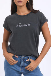 A model wearing the Elements Signature Cotton Tee in colour Black (Black), from the front, cropped image