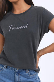 A model wearing the Elements Signature Cotton Tee in colour Black (Black), from the front, cropped image