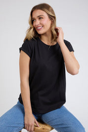 A model wearing the Elements Manly Cotton Tee in colour Black (Black), from the front, cropped image
