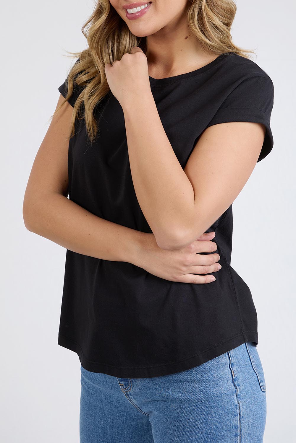 A model wearing the Elements Manly Cotton Tee in colour Black (Black), from the front, cropped image