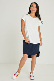 Model Katie wearing size 10 of the Elements Manly Cotton Tee in colour White (White), from the front, showing the whole outfit