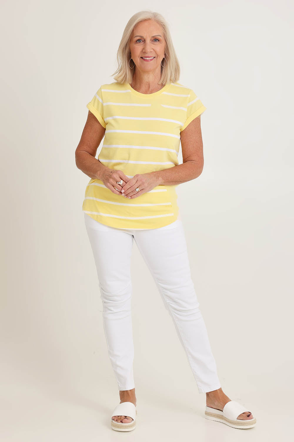 Model Sandy wearing size 10 of the Elements Manly Stripe Cotton Tee in colour Sunshwhite, from the front, showing the whole outfit