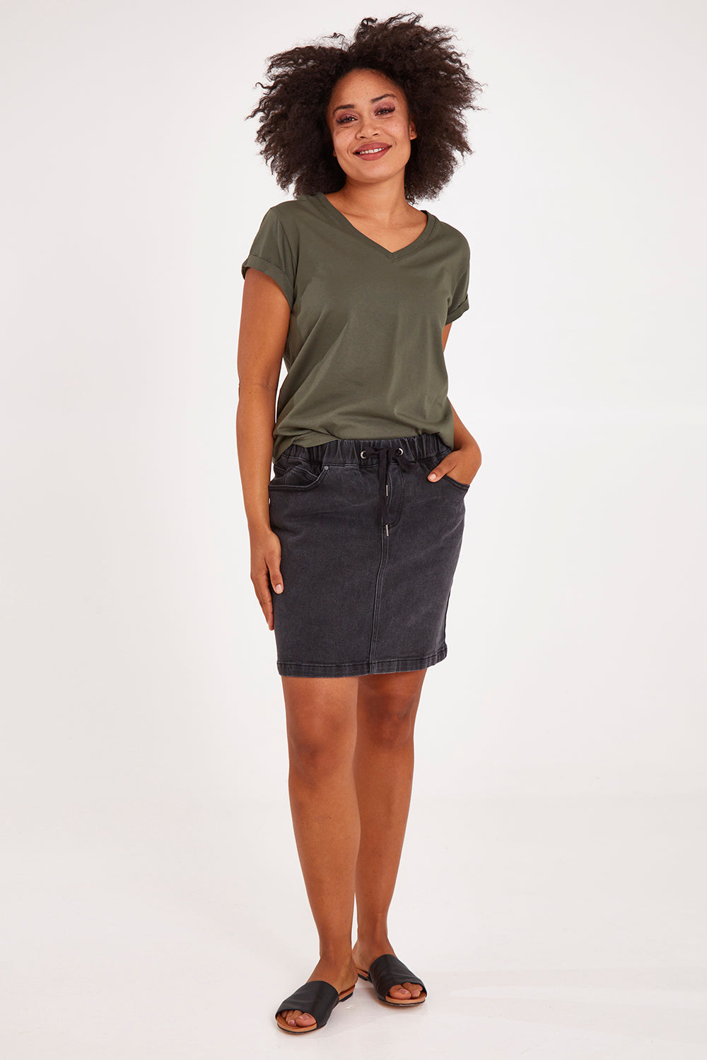 Model Olivia wearing size 10 of the Elements Manly Cotton Vee Tee in colour Khaki (Green), from the front, showing the whole outfit