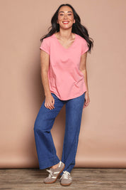 Model Katie wearing size 8 of the Elements Manly Cotton Vee Tee in colour Rosepink (Pink), from the front, showing the whole outfit
