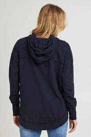 Model Grace wearing size 10 of the Elements Sigrid Hoody in colour Dksapphire (Blue), from the back