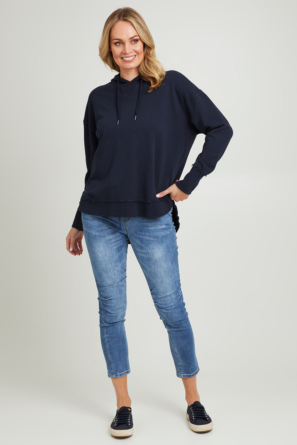 Model Grace wearing size 10 of the Elements Sigrid Hoody in colour Dksapphire (Blue), from the front, showing the whole outfit